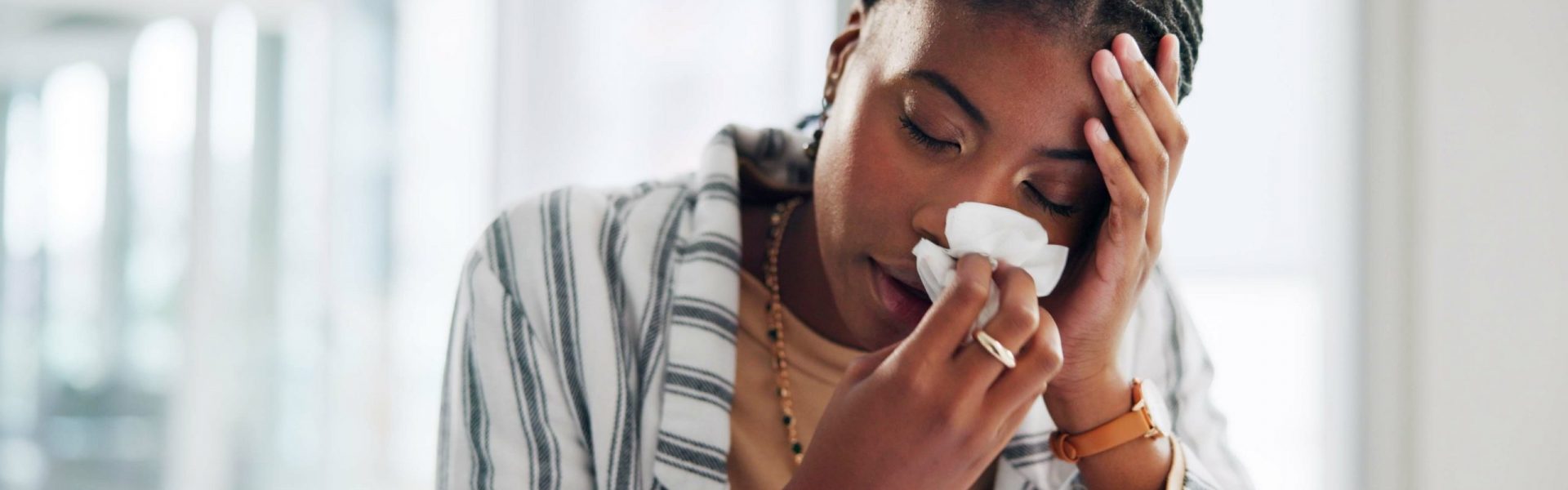 Black woman, sick professional and blowing nose in office, allergies and tissue for virus influenza. Female person, respiratory disease and hayfever cold in workplace, sinus infection and pneumonia Black woman, sick professional and blowing nose in office, allergies and tissue for virus influenza. Female person, respiratory disease and hayfever cold in workplace, sinus infection and pneumonia.